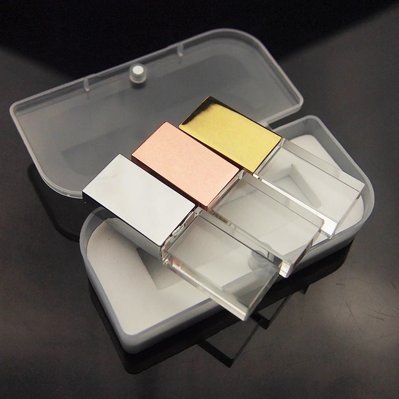 Trio Of Silver, Rose Gold and Gold Block USB's Resting On Case