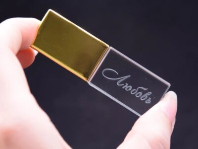 Person Holding Transparent and Gold Block USB