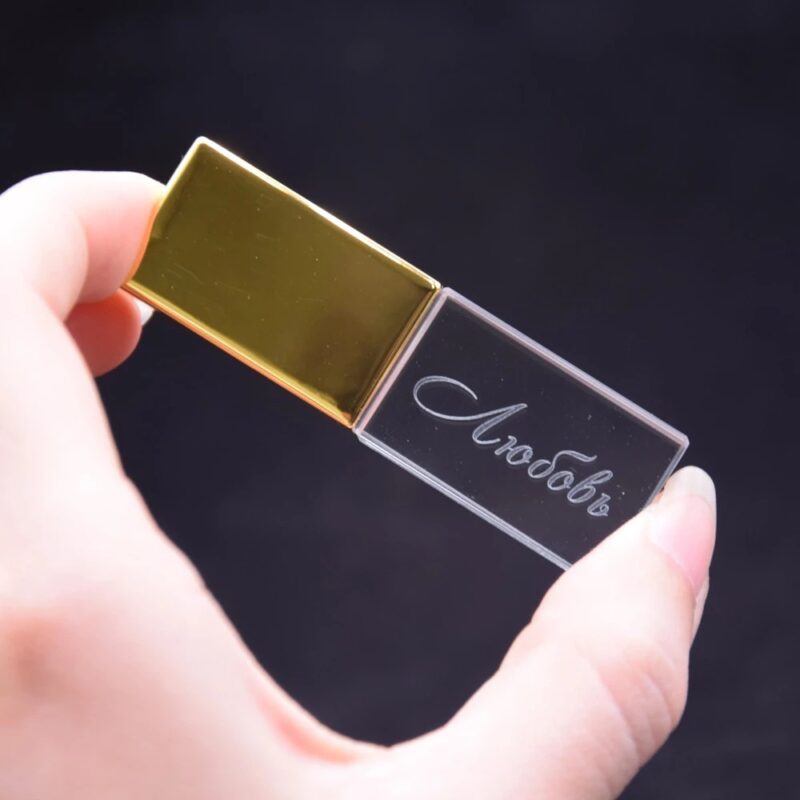 Person Holding Transparent and Gold Block USB