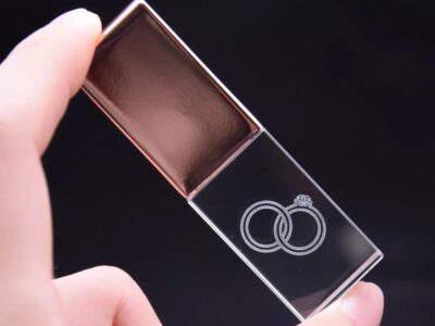 Person Holding Transparent and Rose Gold Block USB