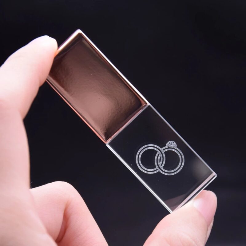 Person Holding Transparent and Rose Gold Block USB