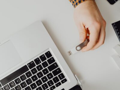 person inserting usb into laptop